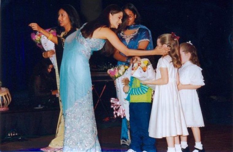 Children receiving flowers at a ceremony